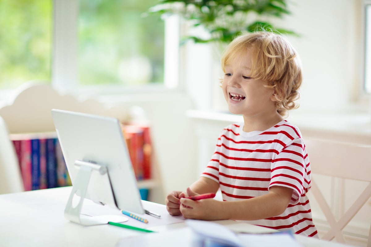 Online remote learning. School kids with computer.